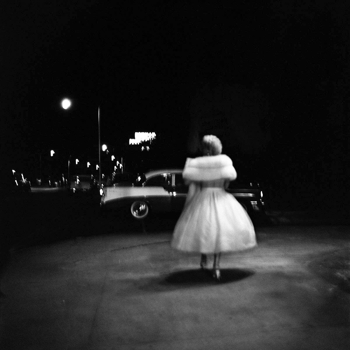 Vivian Maier walked the streets at night capturing subjects in motion, such as this woman in white.