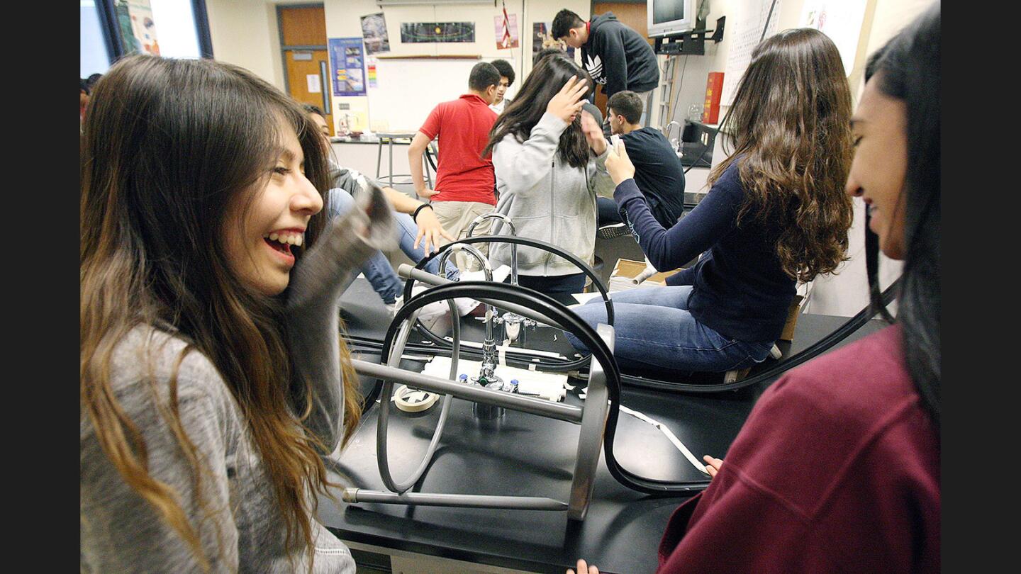 Stools, tape, and PCV are used to support rubber with a track that 4 teams are using to make a roller coaster to successfully roll a heavy marble from one end to the other in the 8th grade science class at Theodore Roosevelt Middle School on Monday, March 13, 2017. The class built the rollercoasters as part of a final project for the physics portion of the school year. They will study astronomy next.