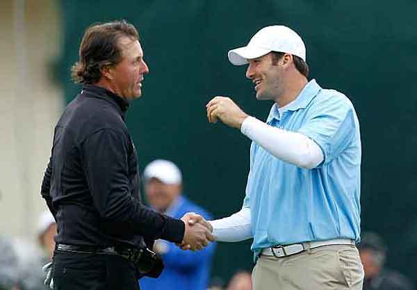 Phil Mickelson is congratulated by Cowboys quarterback Tony Romo, who was paired with Tiger Woods, after Mickelson finished his round of 64 to clinch his 40th PGA Tour victory at 17 under on Sunday at the AT&T Pebble Beach National Pro-Am.