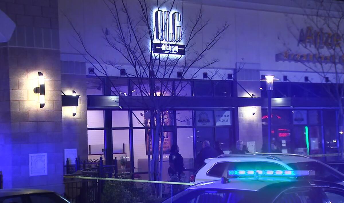 In this image from video provided by WSB-TV, police officers stand outside Old Lady Gang restaurant Friday, Feb. 14, 2020, in East Point, Ga. 