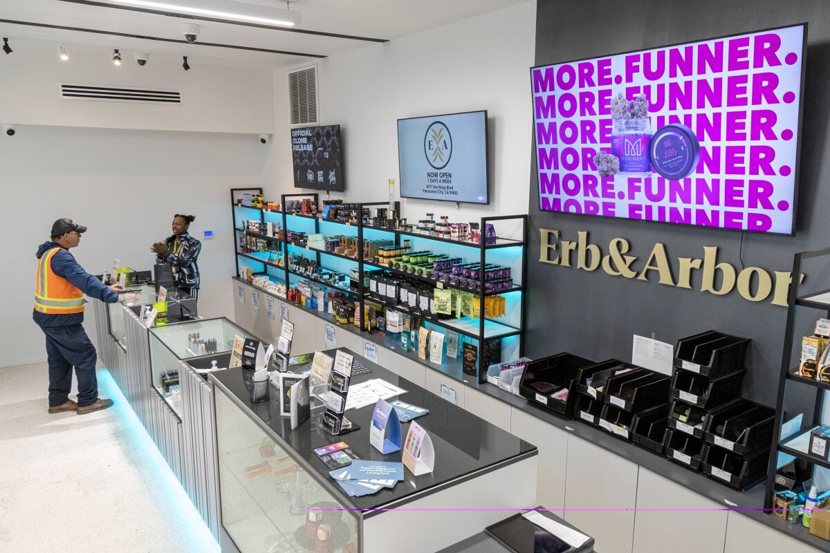 The interior of a dispensary with two people at the counter