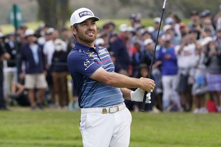 Louis Oosthuizen, of South Africa, hits from the 18th fairway during the final round of the U.S. Open Golf Championship.