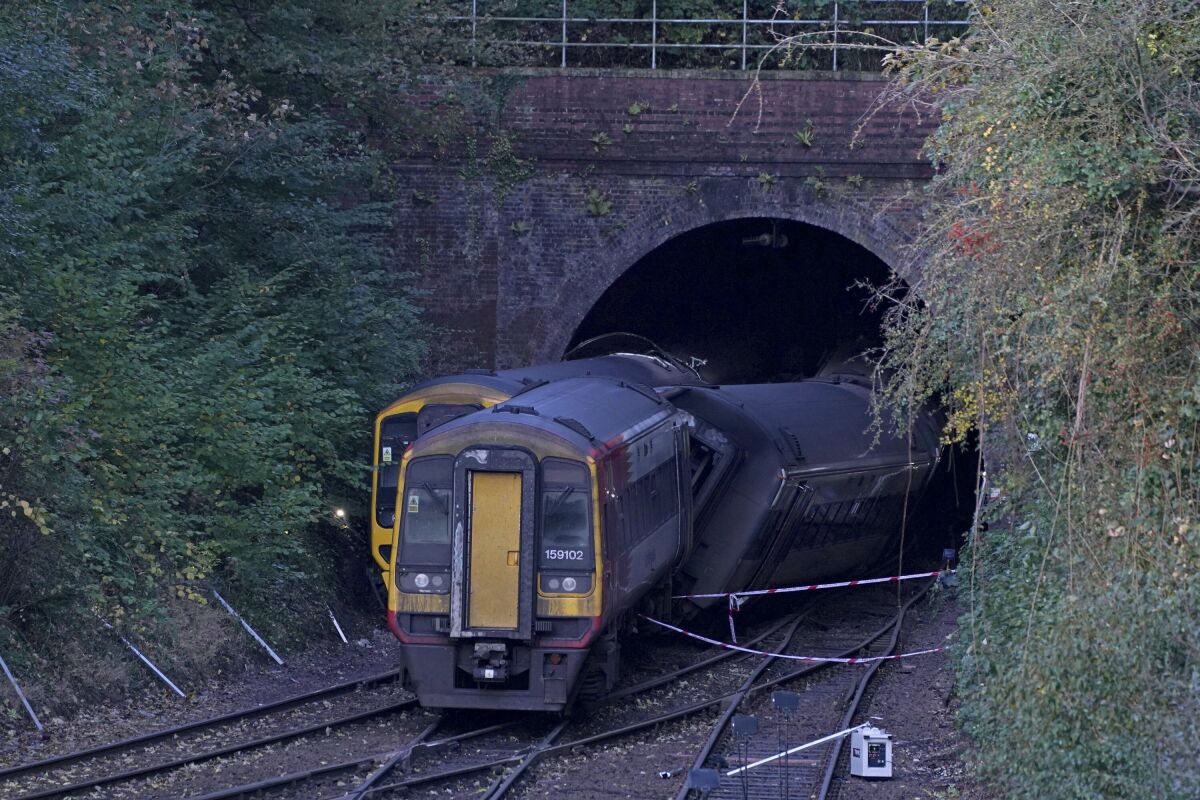 The scene of a crash involving two trains near the Fisherton Tunnel between Andover and Salisbury in Wiltshire, England early Monday, Nov. 1, 2021. Two passenger trains crashed after one of them derailed in the southern English city of Salisbury, and several people were injured, authorities said Sunday. (Steve Parsons/PA via AP)