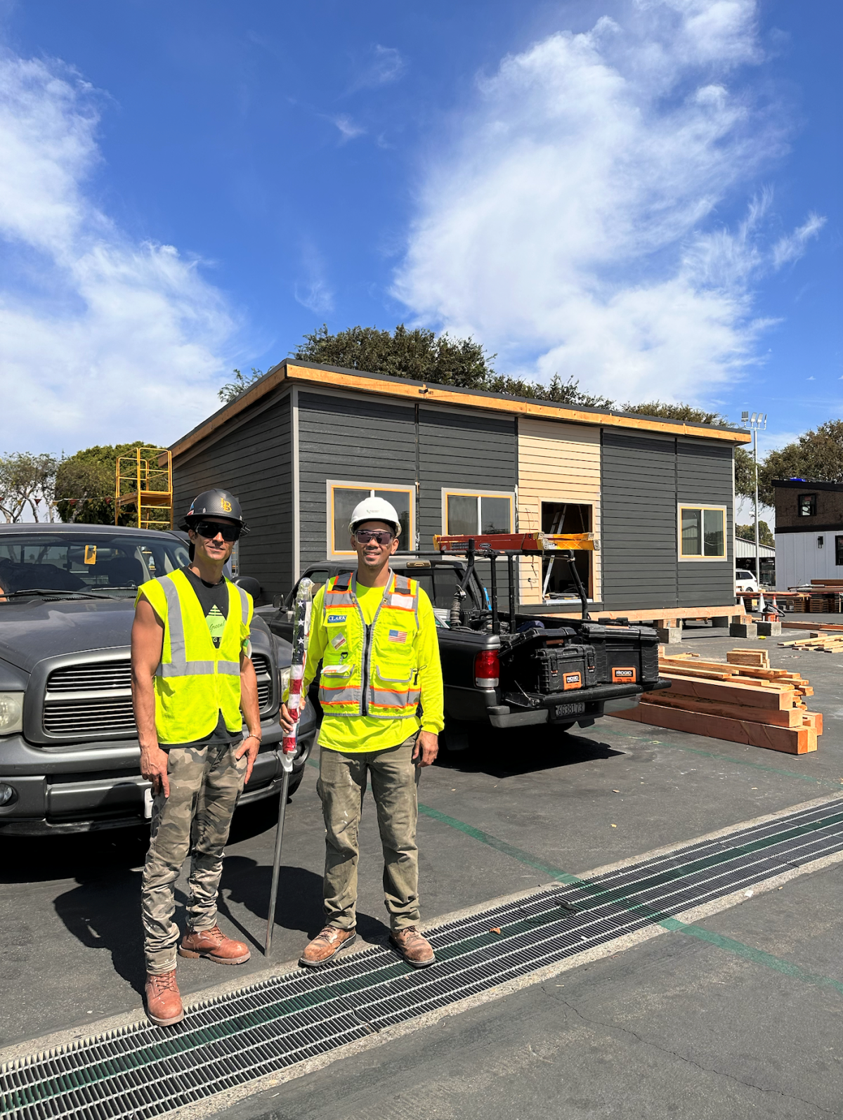 A build team from CSU Long Beach poses in front of a sustainable model home.