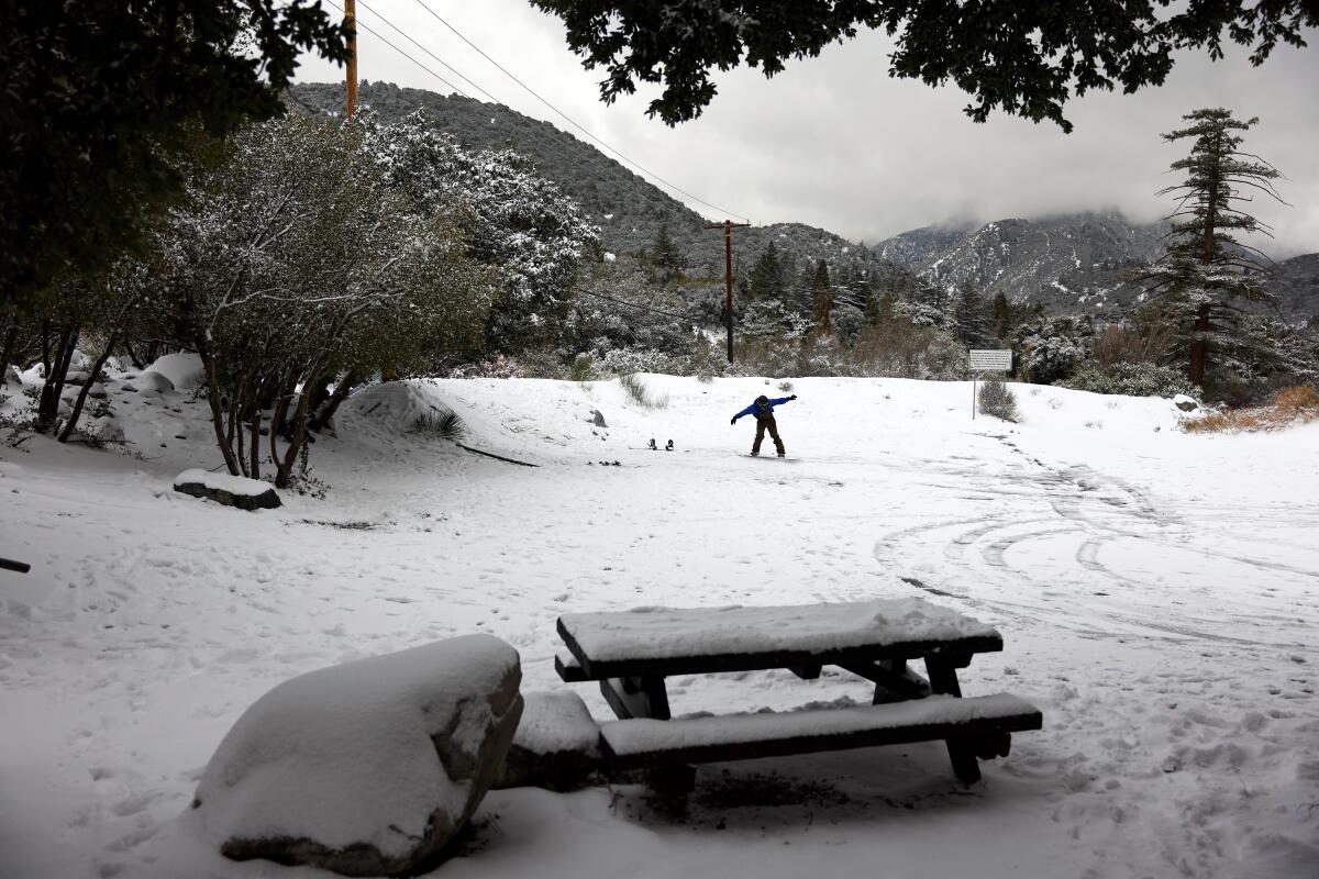 A person snowboards at a rest area in the San Gabriel Mountains.