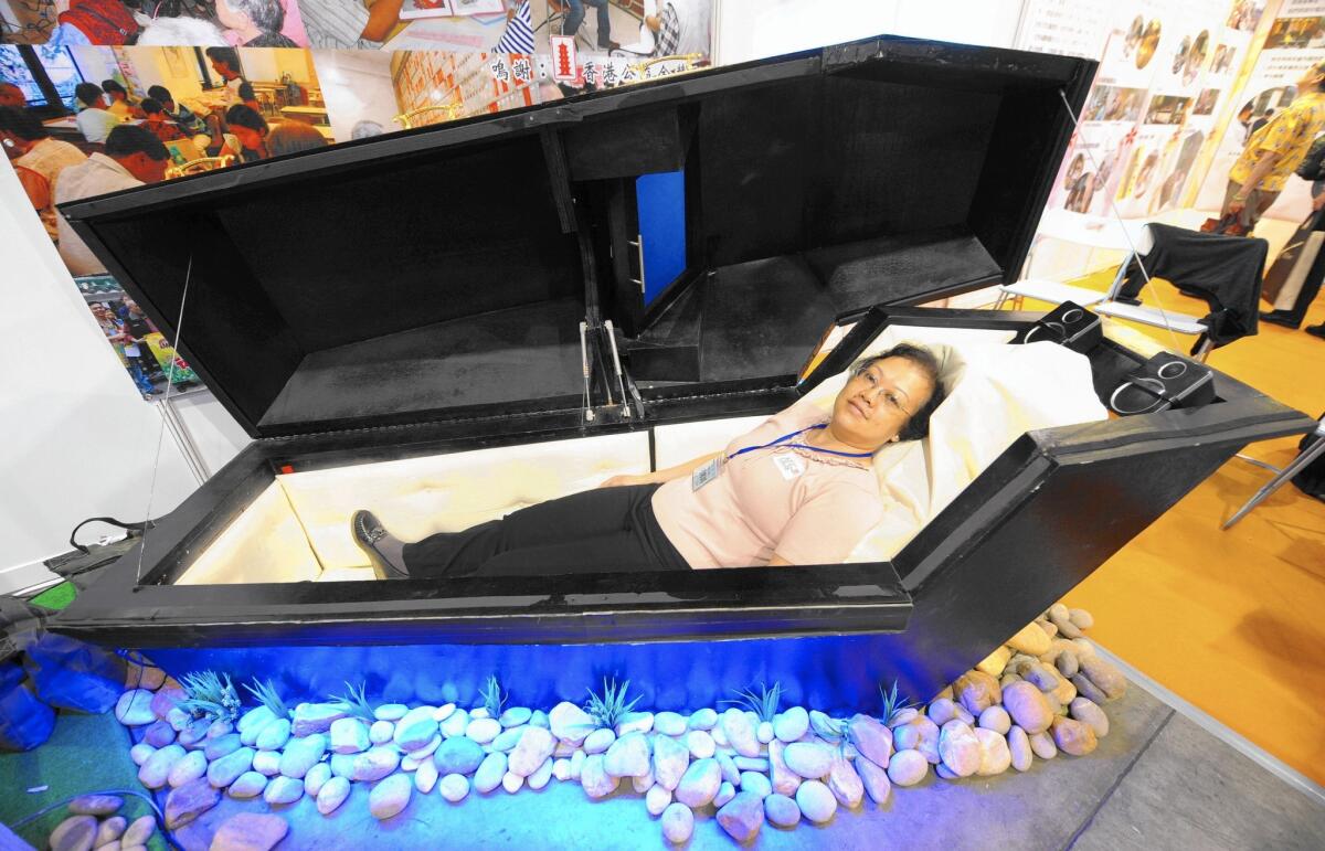 Guests are invited to check out a coffin at a funeral expo in Hong Kong in 2009.