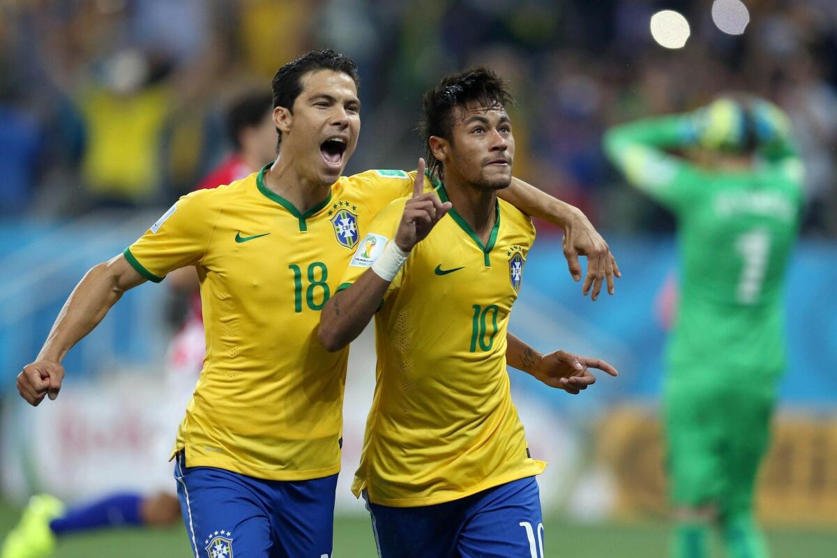 Brazil star Neymar (10) celebrates a goal with teammate Hernanes (18) during a 3-1 victory over Croatia in a World Cup Group A game on Thursday.