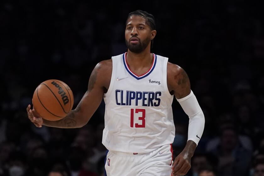 Los Angeles Clippers guard Paul George (13) controls the ball during an NBA basketball game.