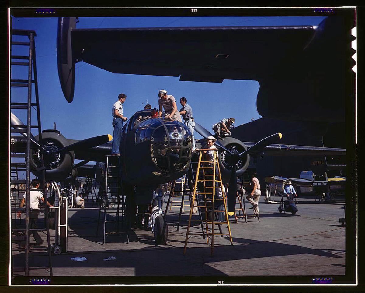 On North American's outdoor assembly line, employees rush a B-25 to completion, North American Aviation in Inglewood. October 1942.