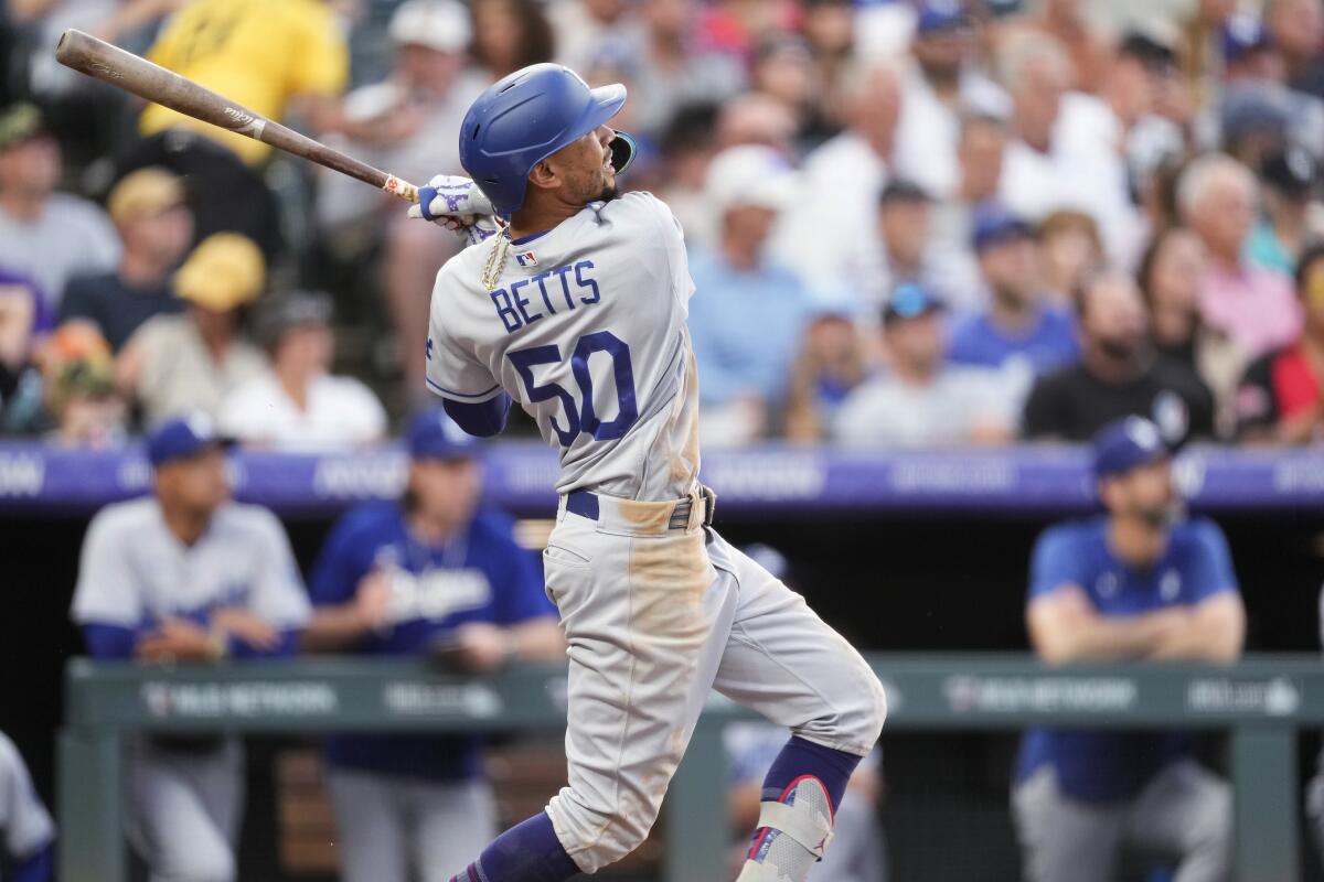 Dodgers' Mookie Betts watches his three-run home run.