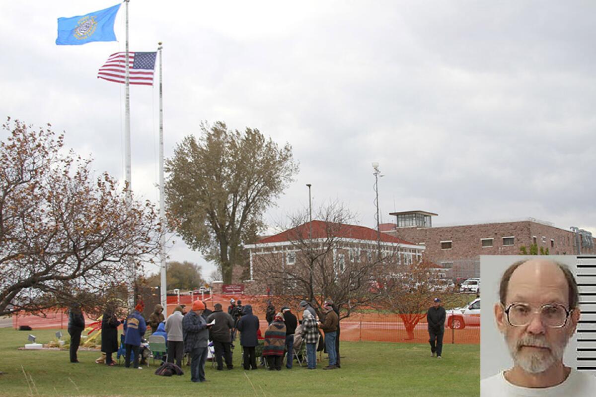 Protesters opposed to the death penalty pray and sing outside South Dakota State Penitentiary in Sioux Falls before the execution of Charles Rhines, inset, on Monday.