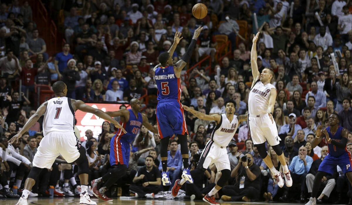 Detroit Pistons' Kentavious Caldwell-Pope (5) shoots over Miami Heat's Gerald Green (14) and Beno Udrih (19) during the second half on Tuesday.