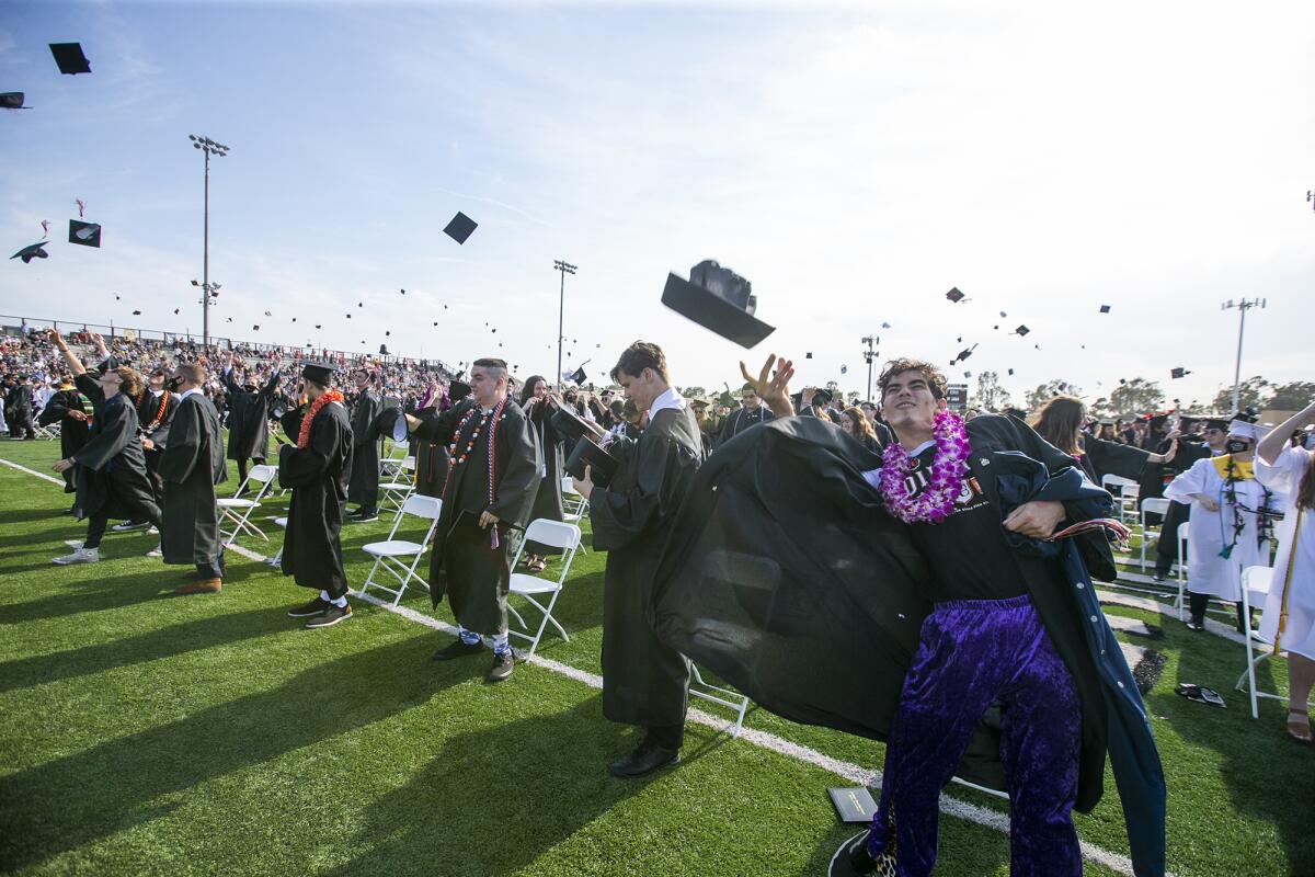 Graduates toss their mortarboards during Huntington Beach High School 2021 commencement ceremony on Tuesday, June 15.