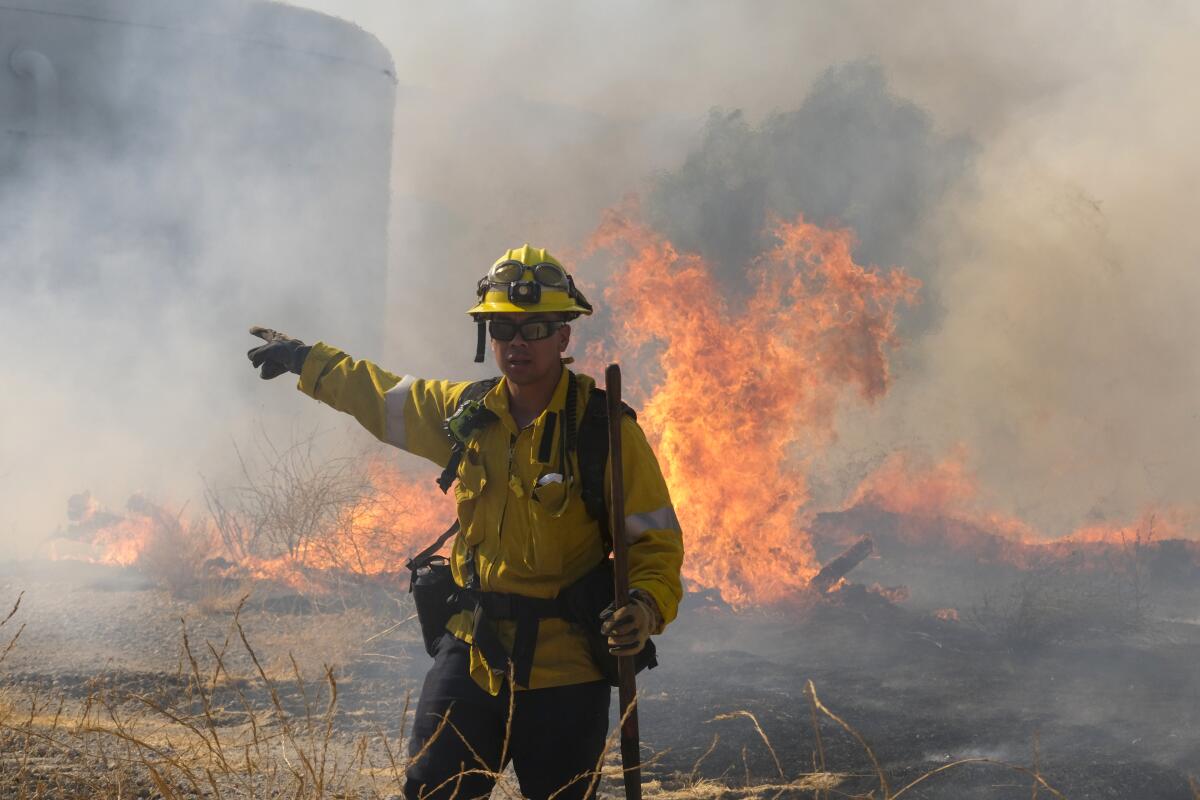 A firefighter battles the Route fire in Castaic on Aug. 31, 2022.