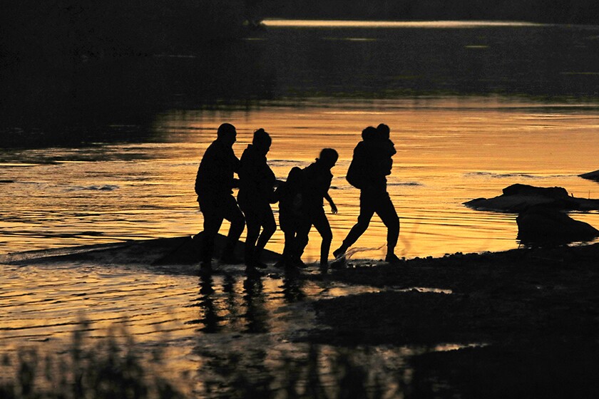 Silhouette of a family crossing the Rio Grande