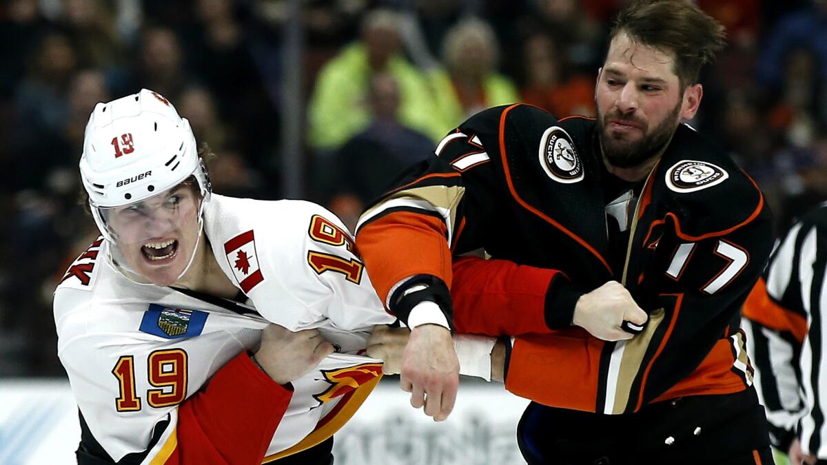 Ducks center Ryan Kesler, right, squares olf with Flames left wing Matthew Tkachuk during the first period Friday night.