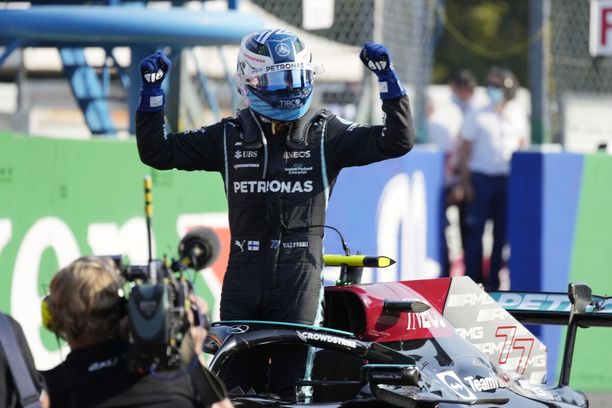Mercedes driver Valtteri Bottas of Finland celebrates winning the Sprint Race qualifying session at the Monza racetrack, in Monza, Italy , Saturday, Sept.11, 2021. The Formula one race will be held on Sunday. (AP Photo/Luca Bruno)