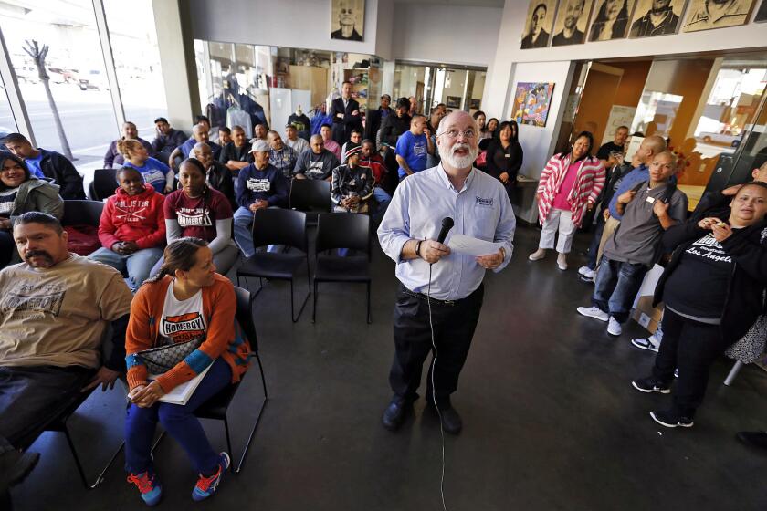 LOS ANGELES, CA - MARCH 5, 2015: Executive Director and Founder of Homeboy Industries, Father Gregory Boyle reads morning notes and a morning prayer to the staff on March 5, 2015 in the 130 W. Bruno St. headquarters which is near the site of a Homeboy Industries expansion into a neighboring building scheduled to open in April. (Al Seib / Los Angeles Times)
