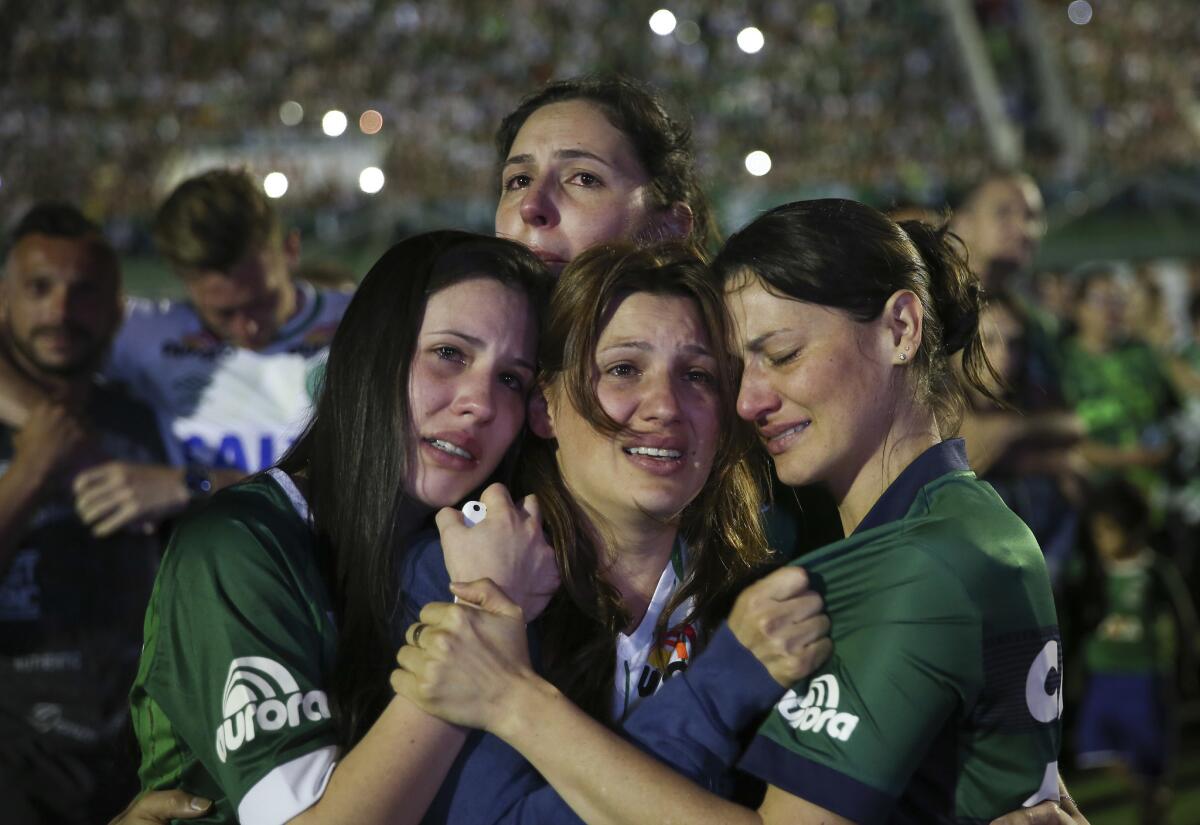 Relatives of Chapecoense soccer players, who died in a plane crash in Colombia, cry during a memorial inside Arena Condado stadium in Chapeco, Brazil, Wednesday, Nov. 30, 2016. Authorities were working to finish identifying the bodies before repatriating them to Brazil. (AP Photo/Andre Penner)