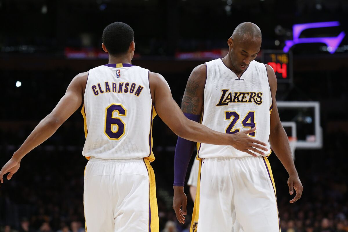 Kobe Bryant is given a pat of support from teammate Jordan Clarkson after they teamed up on a play against the Pacers.