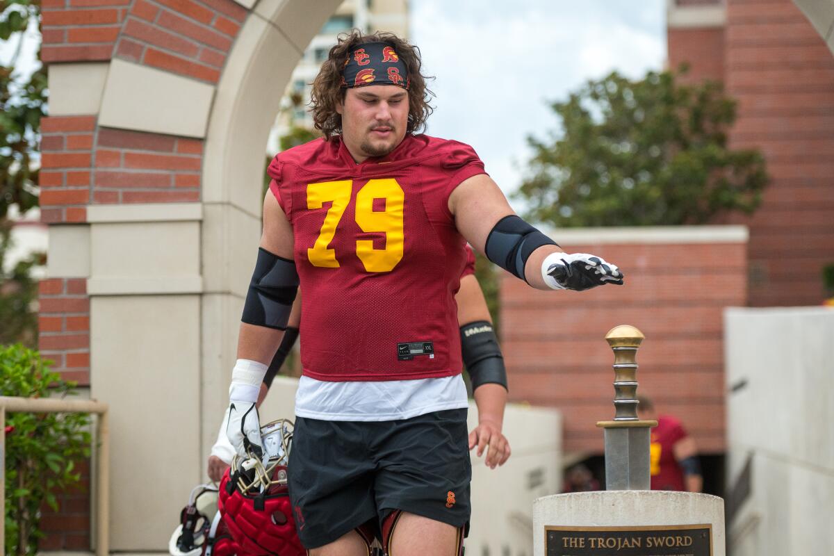 LOS ANGELES, CA - AUG. 5, 2022: USC offensive lineman Jonah Monheim taps a sword.