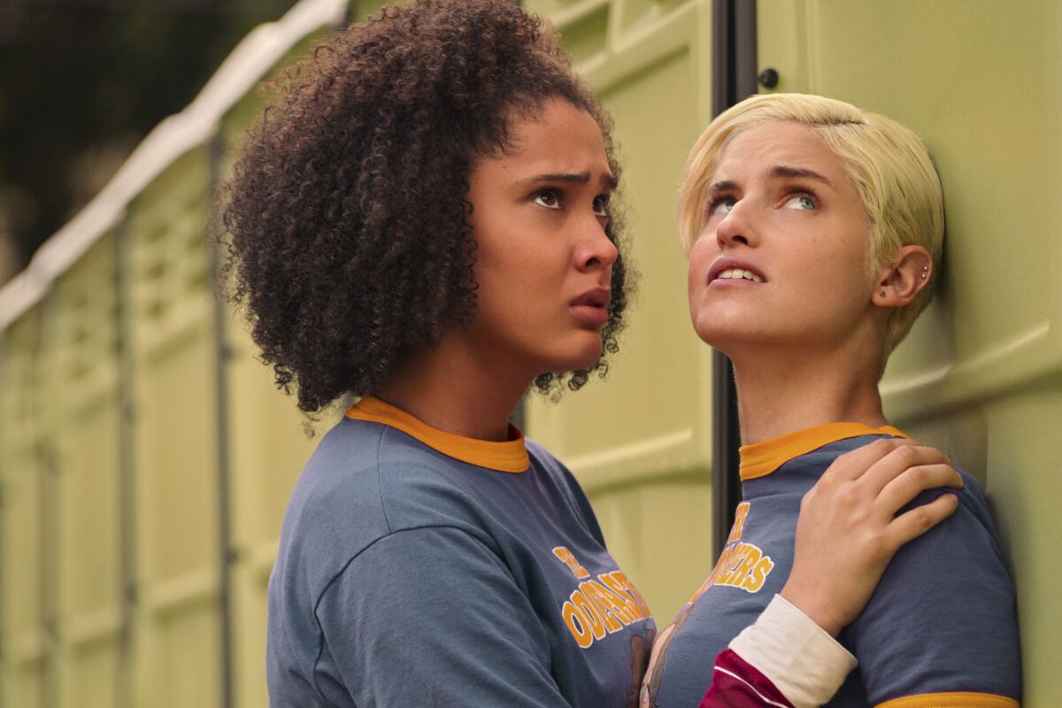 This image released by Netflix shows Lee Rodriguez, left, and Christina Kartchner in a scene from "Never Have I Ever." (Netflix via AP)