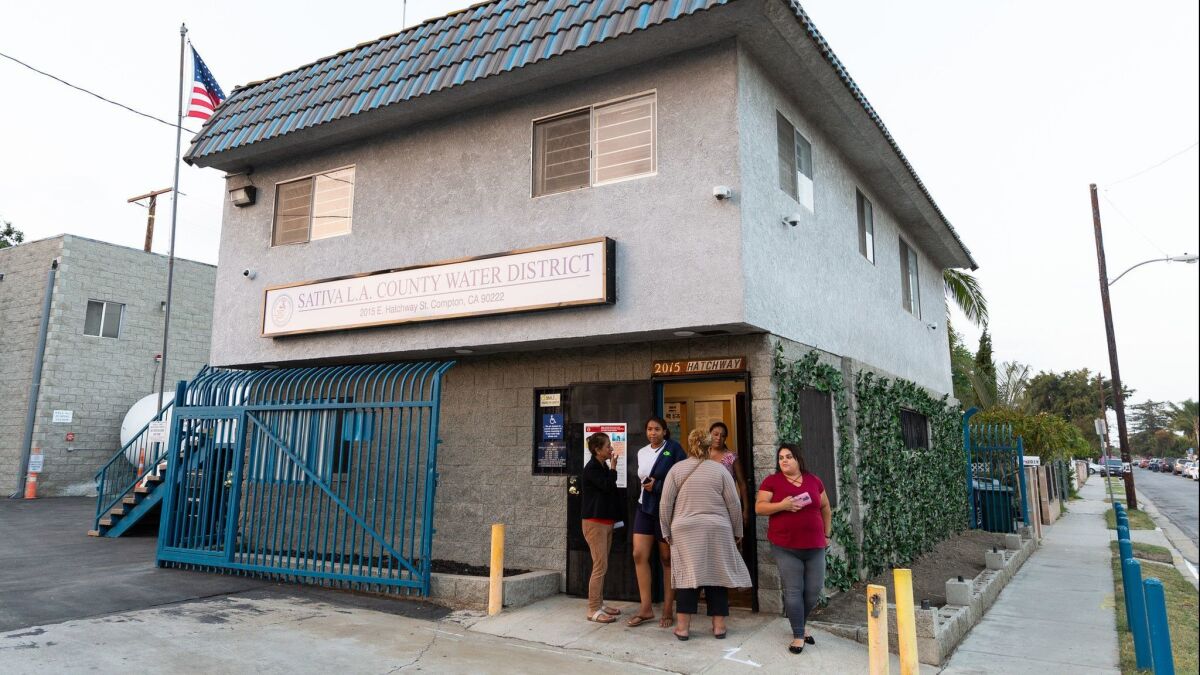 Residents gather outside the Sativa Los Angeles County Water District office during a June meeting.