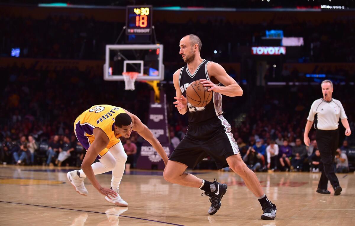 Spurs guard Manu Ginobili gets away from Lakers defender Jordan Clarkson on Friday.