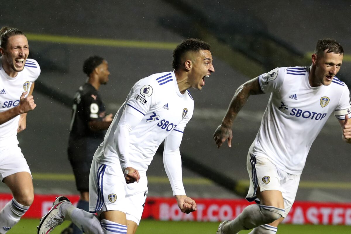 Leeds United's Rodrigo, center, celebrates after scoring his side's first goal during the English Premier League soccer match between Leeds United and Manchester City at Elland Road in Leeds, England, Saturday, Oct. 3, 2020. (Cath Ivill/Pool via AP)