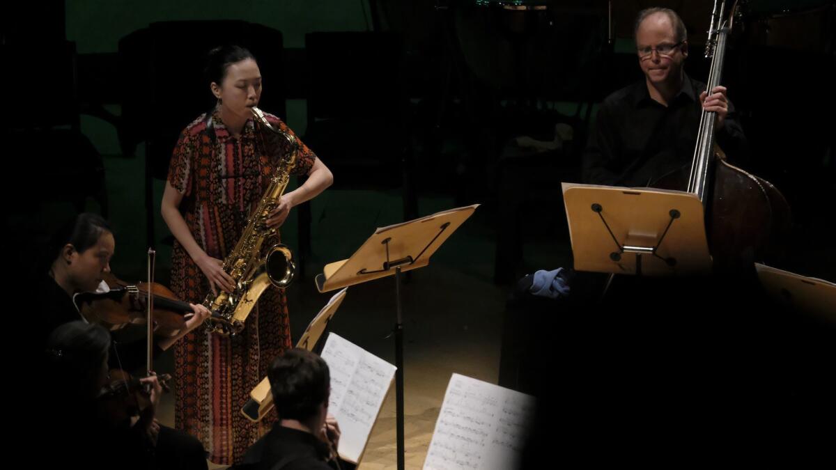 Saxophonist Hitomi Oba solos in her new piece, "Aina," with the Los Angeles Philharmonic New Music Group as part of a Green Umbrella program at Walt Disney Concert Hall Tuesday night.