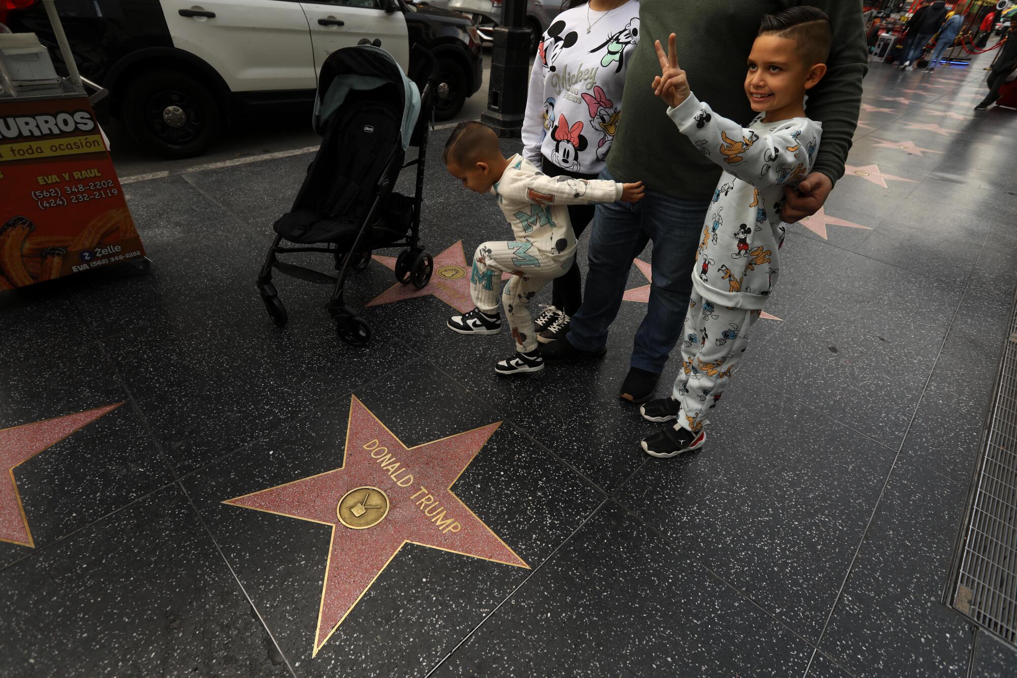 Visitors pose for pictures next to Donald Trump's star on the Hollywood Walk of Fame in Hollywood on Dec. 22.
