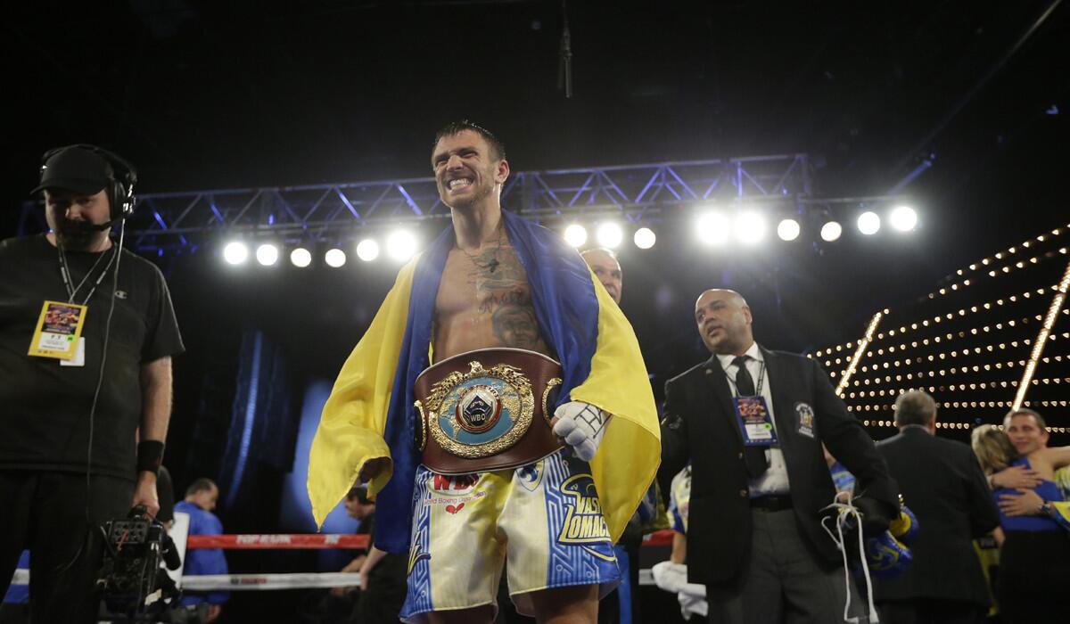 Vasyl Lomachenko celebrates after winning the WBO junior lightweight title by knocking out Roman "Rocky" Martinez in June. He is expected to face Nicholas Walters in Las Vegas on Nov. 26.