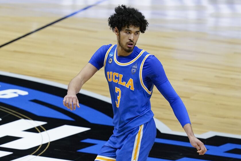 UCLA guard Johnny Juzang runs up court after making a basket during the second half of an Elite 8 game.