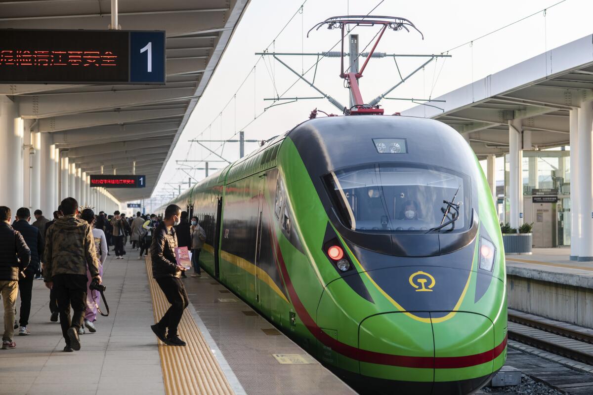 In this photo released by Xinhua News Agency, an electric multiple unit (EMU) train of the China-Laos Railway arrives at Yuxi Railway Station in Yuxi in southwestern China's Yunnan Province, Friday, Dec. 3, 2021. The China Laos railway is one of hundreds of projects under Beijing's Belt and Road Initiative to build ports, railways and other facilities across Asia, Africa and the Pacific. (Hu Chao/Xinhua via AP)