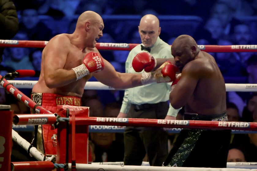 Tyson Fury, left, lands a punch during his WBC heavyweight championship boxing match against Derek Chisora at Tottenham Hotspur's White Hart Lane stadium London, Saturday Dec. 3, 2022.(AP Photo/Ian Walton)