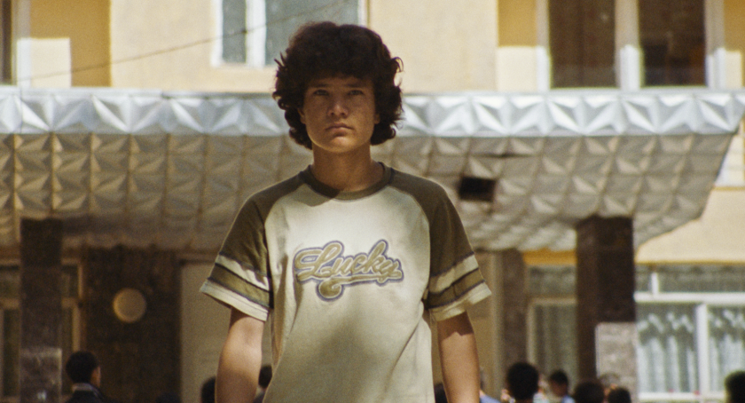 A boy in a T-shirt on a street