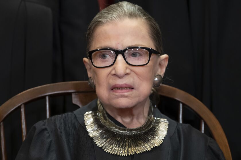 FILE - In this Nov. 30, 2018 file photo, Associate Justice Ruth Bader Ginsburg, nominated by President Bill Clinton, sits with fellow Supreme Court justices for a group portrait at the Supreme Court Building in Washington, Friday. The Supreme Court says Justice Ruth Bader Ginsburg has undergone surgery to remove two malignant growths from her left lung. It is Ginsburgs third bout with cancer since joining the court in 1993. (AP Photo/J. Scott Applewhite)