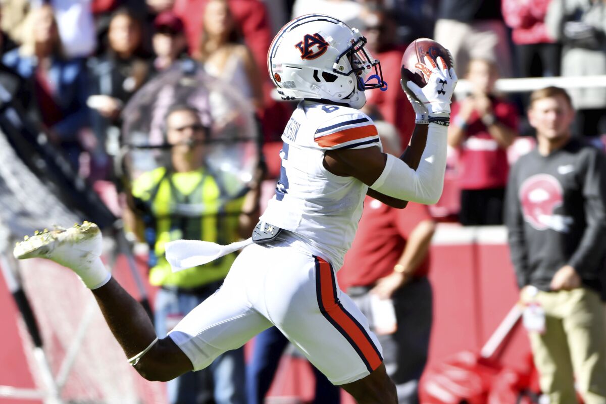 Auburn receiver Ja'Varrius Johnson (6) scores a touchdown against Arkansas during the first half of an NCAA college football game Saturday, Oct. 16, 2021, in Fayetteville, Ark. (AP Photo/Michael Woods)
