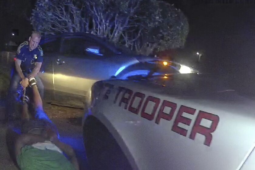 An image taken from police body-cam video shows Louisiana Master Trooper Kory York dragging the body of Dakota DeMoss.