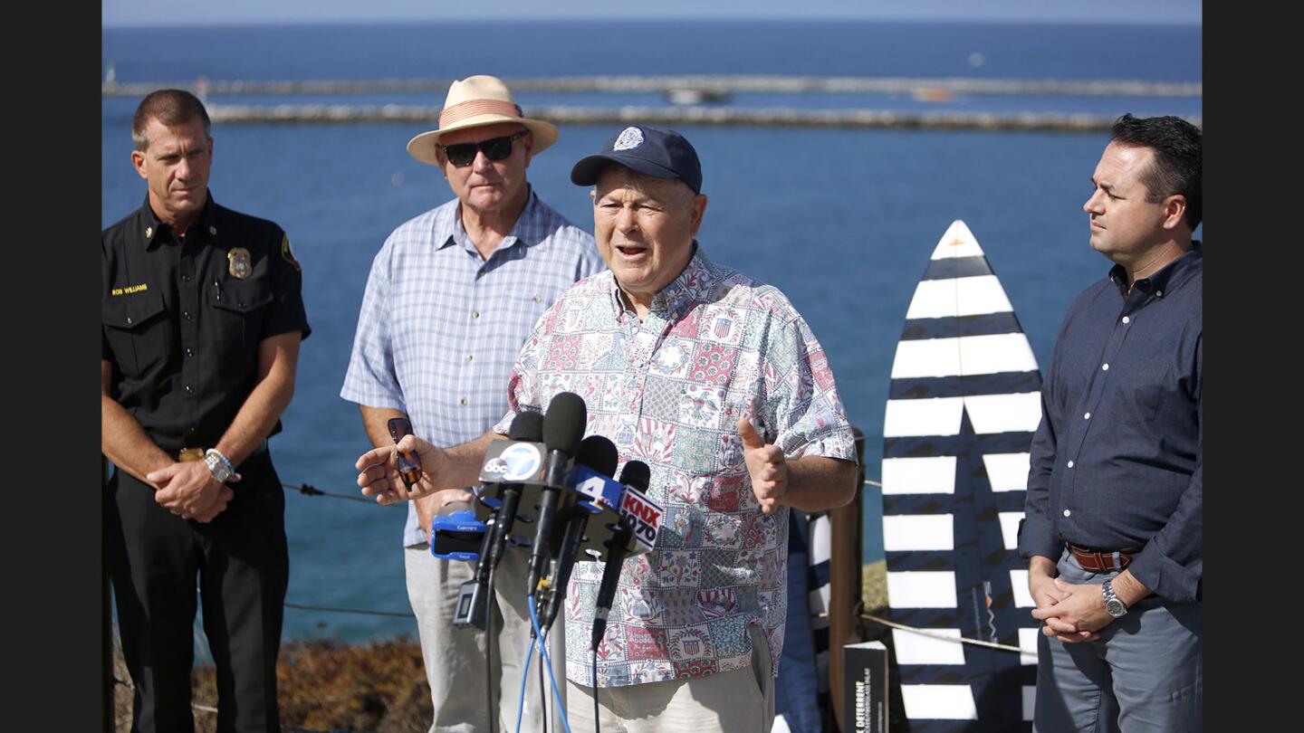 Rep. Dana Rohrabacher talks about a pilot project to prevent shark attacks along the Corona del Mar coastline during a news conference at Inspiration Point in Corona Del Mar on Friday, Sept. 22, 2017. From left are Newport Beach chief lifeguard Rob Williams, Shark Mitigation Systems representative Ian Cairns, Rohrabacher and Mayor Kevin Muldoon.