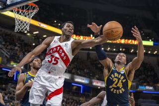 Toronto Raptors center Christian Koloko (35) reaches for the ball as he battles Indiana Pacers guard Buddy Hield (24) for a rebound during the first half of an NBA basketball game in Indianapolis, Monday, Jan. 2, 2023. (AP Photo/Doug McSchooler)