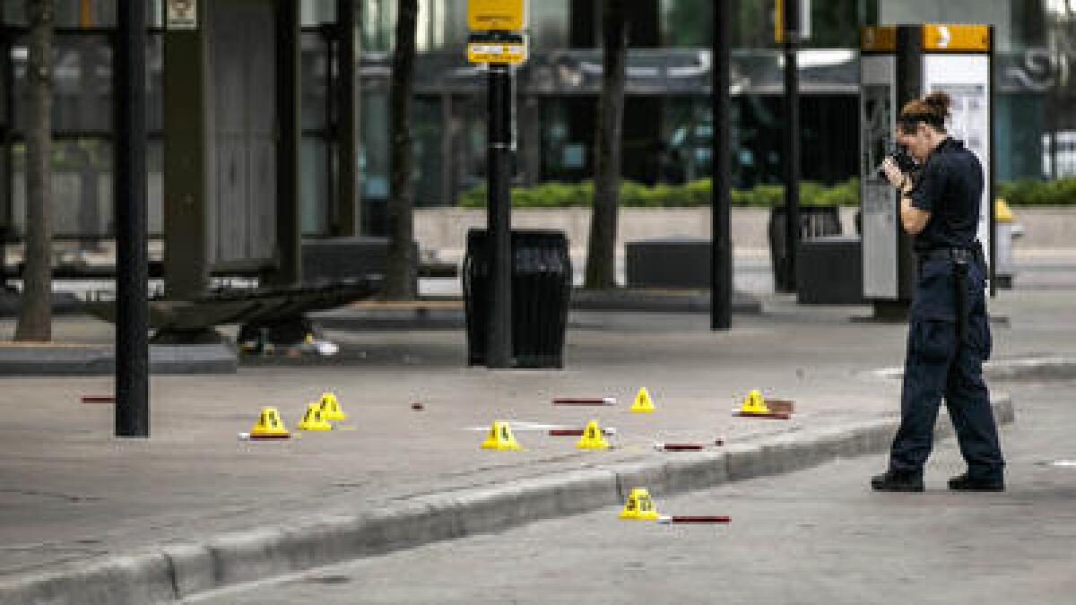 Investigators document the crime scene in Dallas, where a sniper killed five police officers and wounded seven others.