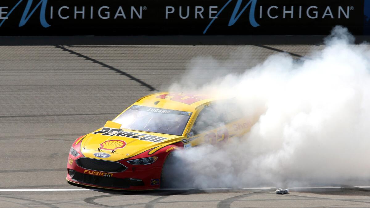 NASCAR driver Joey Logano does a burnout to celebrate his victory in the Sprint Cup Series at Michigan International Speedway on Sunday.
