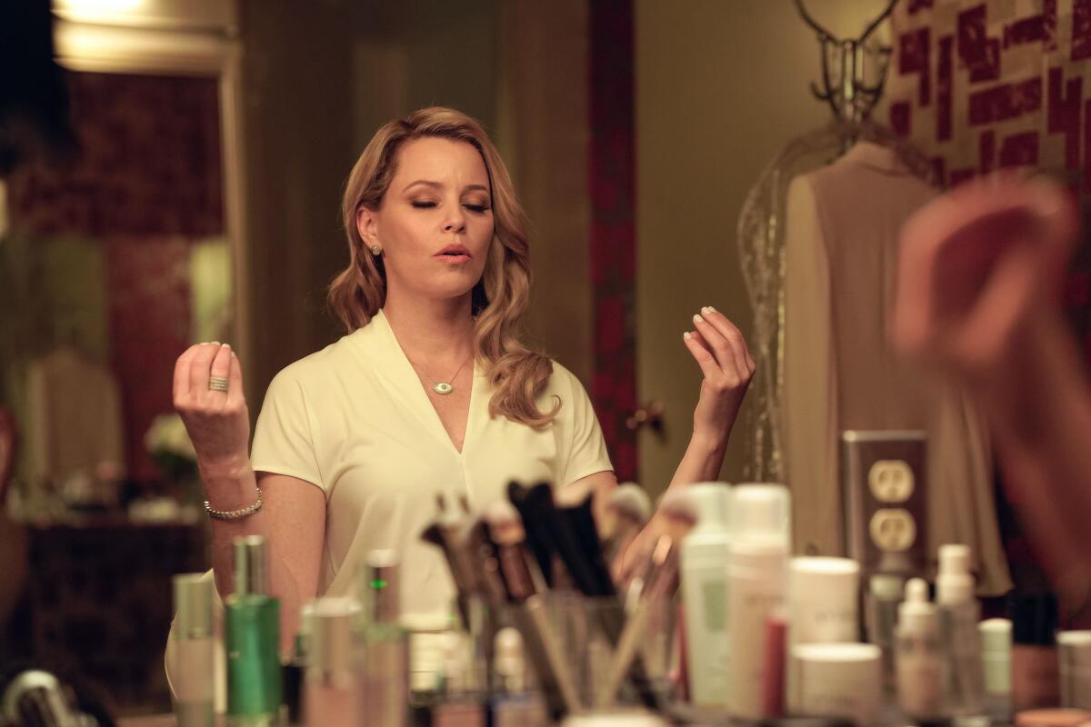 A woman sits at her mirror, meditating.