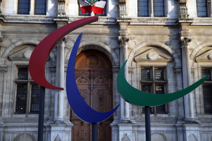 FILE - The logo of the Paris 2024 Paralympic Games is pictured in front of the Paris town hall, France, Friday, Nov. 10, 2017. Votes are taking place Friday, Sept 29, 2023, on whether to “partially suspend” Russia from the International Paralympic Committee. That could mean Russia sends competitors to the Paralympics in Paris next year but that they have to compete as neutral athletes without national symbols. (AP Photo/Christophe Ena, File)