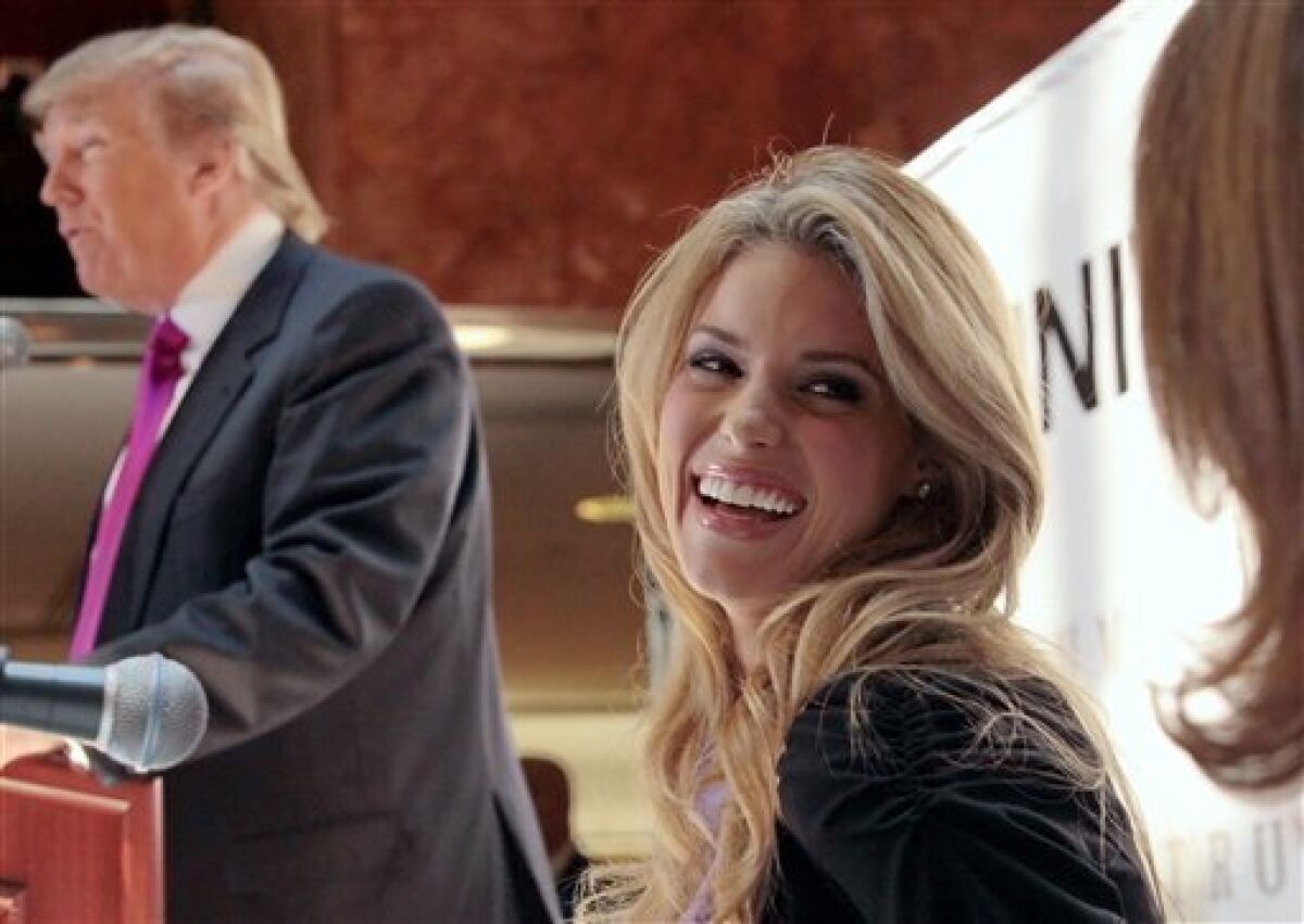 Miss California USA, Carrie Prejean, reacts as Donald Trump, left, speaks during a news conference in New York, Tuesday May 12, 2009. Trump, who owns the Miss USA pageant, says Prejean can retain her Miss California USA crown after she caused a stir expressing opposition to gay marriage and posing in racy photographs. (AP Photo/Bebeto Matthews)