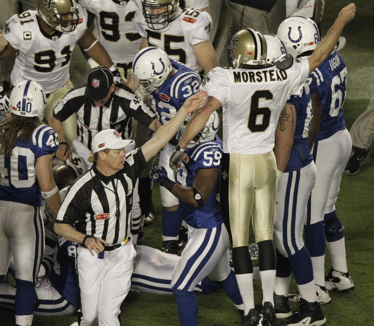 Saints punter Thomas Morstead reacts as an official signals New Orleans will have possession of the ball after an onside kick to open the second half of Super Bowl XLIV.