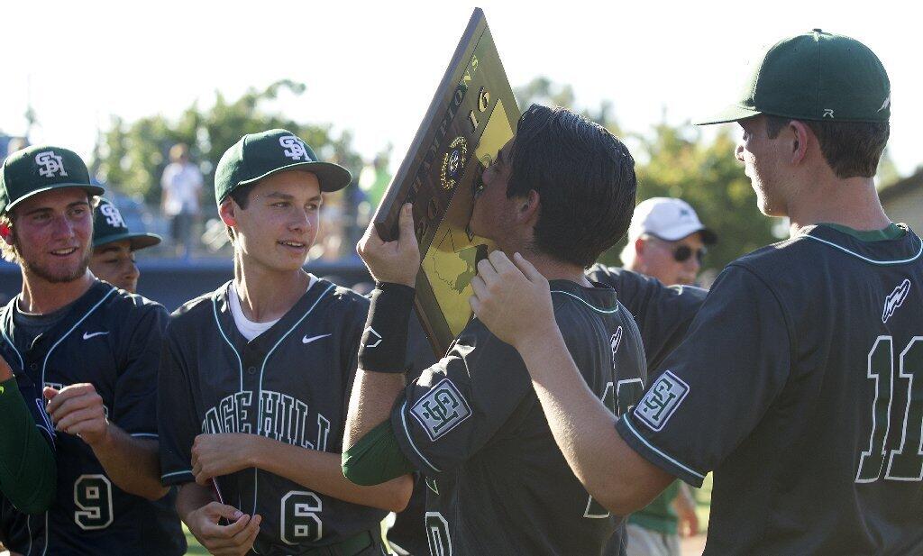 Sage Hill School's Toby Bush kisses the championship plaque after the Lightning beat Crean Lutheran, 9-0, in the CIF-SS Division 6 baseball championship game at UCR Sports Complex in Riverside on Saturday.