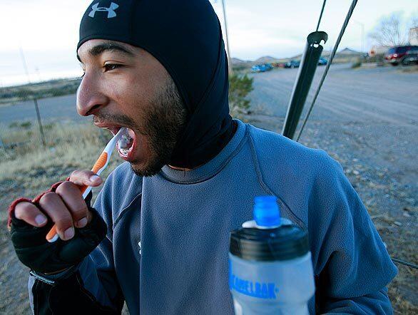 Ryan Bowen of Highland Park, Calif., is riding across the country to Washington to attend Barack Obama's inauguration. In Las Cruces, N.M., he brushes his teeth after a breakfast of fruit and power bars to fortify him for the day's ride.