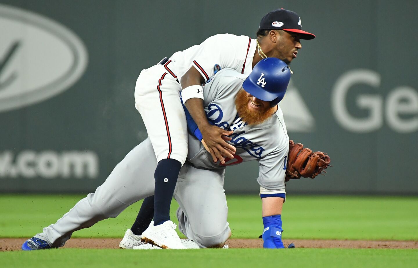 Dodgers Justin Turner is forced out at 2nd base by Braves second baseman Ozzie Albies.